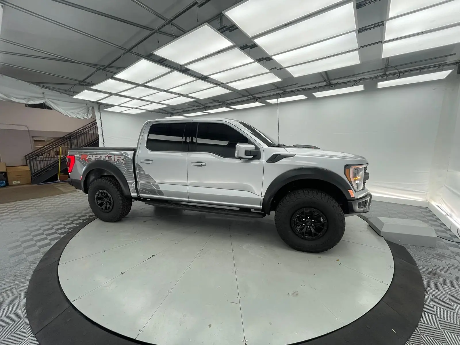 White Ford F-150 Raptor with window tinting